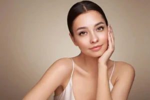 Model posing with glowing skin for facial treatment in Niceville, FL | Blissful Beauty Bar