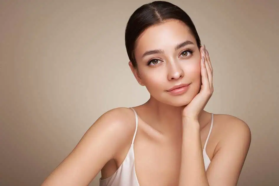 Model posing with glowing skin for facial treatment in Niceville, FL | Blissful Beauty Bar