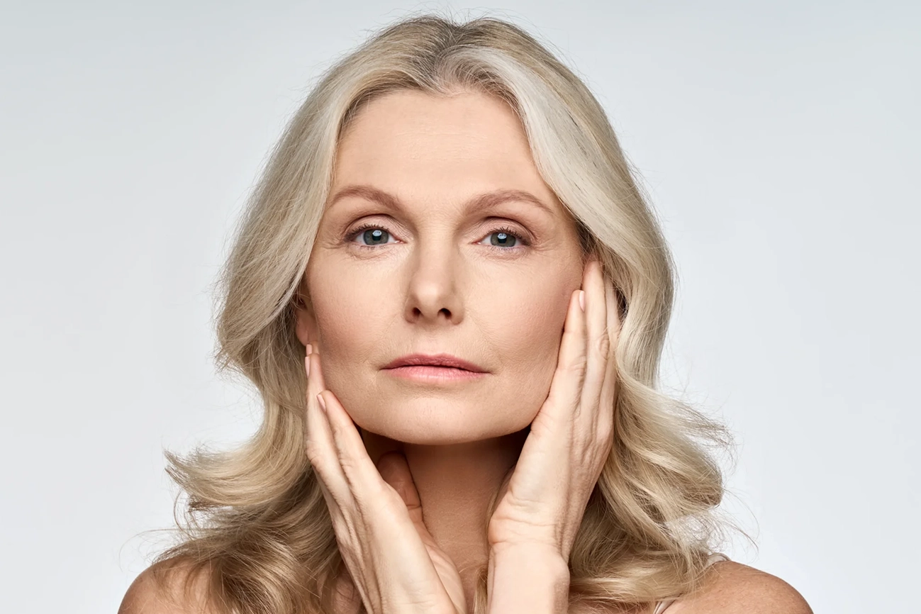 Mature woman showcasing anti-aging skincare results in Niceville, FL | Blissful Beauty Bar